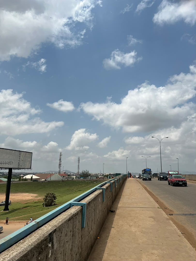 Open road beneath a bright cloud-filled sky